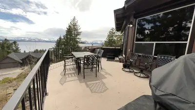 a patio with a table and chairs on a balcony at The Heights home in Zephyr Cove