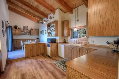a large kitchen with wooden cabinets and a counter top at Lake View Glen home in Lincoln Park