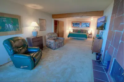 a living room with a couch chair and a bedroom at Lake View Glen home in Lincoln Park