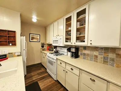 a kitchen with white cabinets and a stove top oven at Cheyenne's Place home in Kings Beach