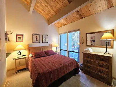 a bedroom with a bed and a large window at Cheyenne's Place home in Kings Beach