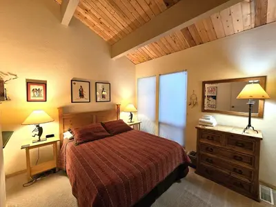 a bedroom with a bed and two lamps and a dresser at Cheyenne's Place home in Kings Beach