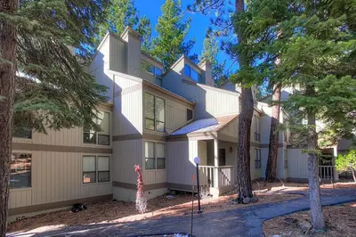 a large building with trees in front of it at Cheyenne's Place home in Kings Beach