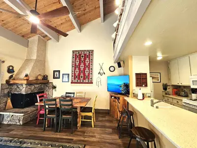 a kitchen and dining room with a table and a fireplace at Cheyenne's Place home in Kings Beach