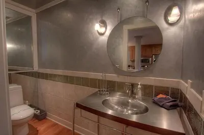 a bathroom with a sink and a mirror and a toilet at Chipmunk's Paradise condo in Kings Beach