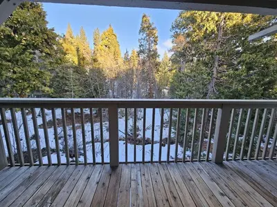 a deck with a view of the woods at Forest View Townhouse home in Kings Beach