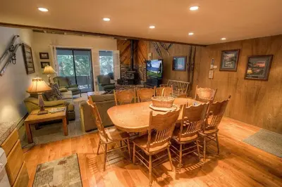 a living room with a wooden table and chairs at Eagle's Lake Retreat condo in Incline Village