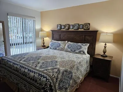a bedroom with a bed and two lamps and a window at Sparrow's Nest home in Incline Village