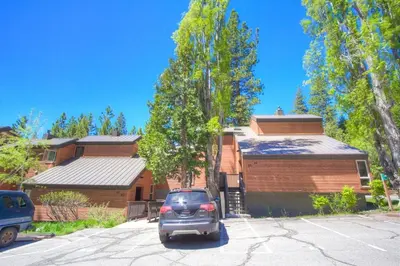 a car parked in a parking lot in front of a house at Alpine Getaway home in Tahoe City