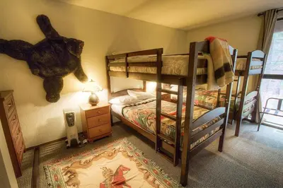 a bedroom with two bunk beds and a teddy bear on the wall at Alpine Getaway home in Tahoe City