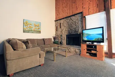 a living room with a couch and a flat screen tv at Tahoe Olympic condo in Stateline