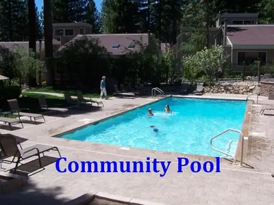 two people swimming in a swimming pool at Tall Pines Retreat condo in Incline Village