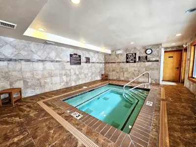 a large swimming pool in a room with at Tall Pines Retreat condo in Incline Village