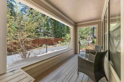 a porch with a large window and chairs on it at Raccoon Roost condo in Incline Village
