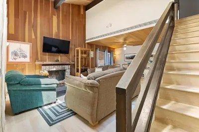 a living room with a couch and a fireplace at Raccoon Roost condo in Incline Village