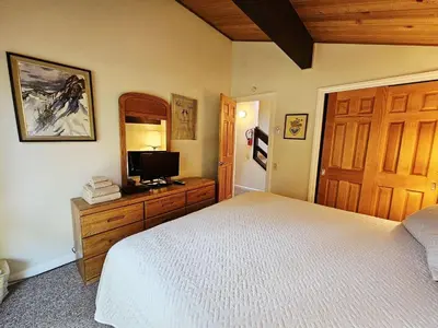 a bedroom with a bed and a television on a dresser at Cartwright Corner Condo townhouse in Incline Village