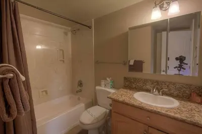 a bathroom with a sink and a toilet and a mirror at Park View Paradise condo in Tahoe City