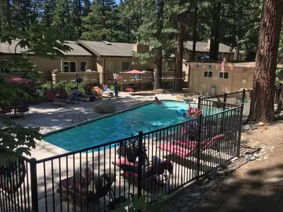 a swimming pool in a yard with a fence at Whispering Wood home in Incline Village