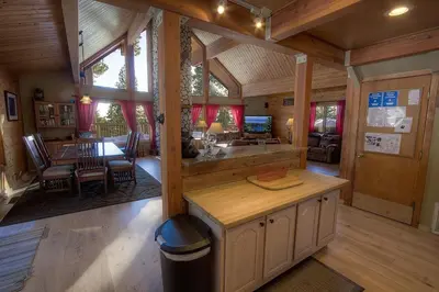 a dining room and living room in a log cabin at The Bass Chalet home in Kings Beach
