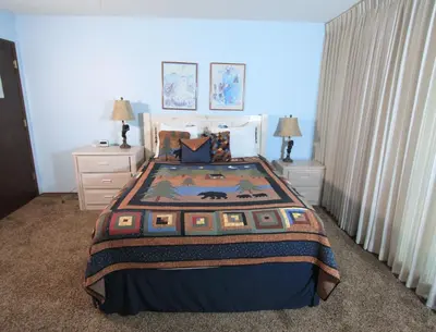 a bedroom with a large bed and two night stands at Lakescape condo in Stateline