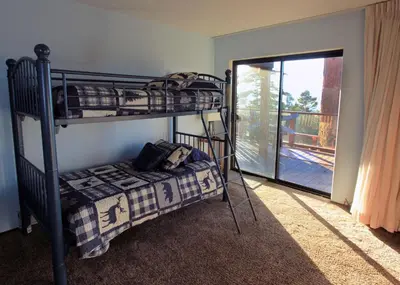 a bedroom with two bunk beds and a balcony at Lakescape condo in Stateline