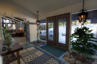 a living room with a door and a potted plant at Blue Laulea home in Incline Village