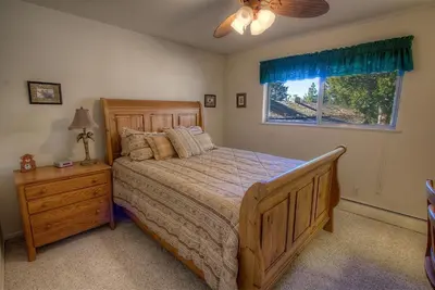 a bedroom with a wooden bed and a window at Cheyenne Chalet home in Round Hill