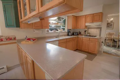 a kitchen with wooden cabinets and a counter top at Cheyenne Chalet home in Round Hill