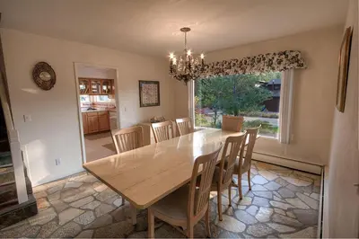 a dining room with a wooden table and chairs at Cheyenne Chalet home in Round Hill