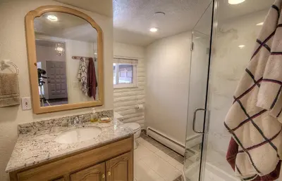 a bathroom with a sink and a shower at Cheyenne Chalet home in Round Hill