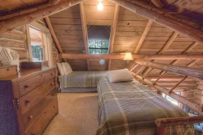 a bedroom with two beds in a log cabin at Zephyr Cabin home in Zephyr Cove