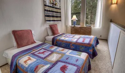 a bedroom with two beds and a window at Kingswood Cornerview home in Kings Beach