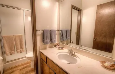 a bathroom with a sink and a toilet and a mirror at Kingswood Cornerview home in Kings Beach