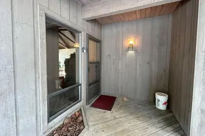 a porch with a window and a red rug at Tumbleweed Pines home in Incline Village