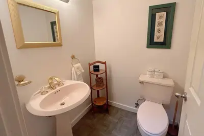 a bathroom with a white toilet and a sink at Tumbleweed Pines home in Incline Village