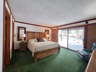 a bedroom with a bed and a large window at Brockway Beachside Bungalo home in Kings Beach