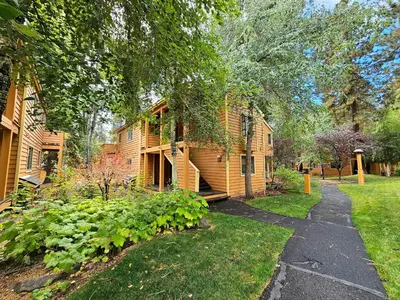 a house with a pathway leading to a yard at Delightful McCloud condo in Incline Village