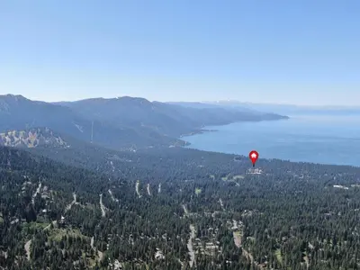 a red hot air balloon flying over a forest at Delightful McCloud condo in Incline Village