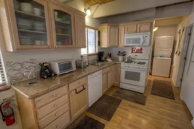 a kitchen with white appliances and wooden cabinets at Cozy Mountain Hideaway home in Incline Village