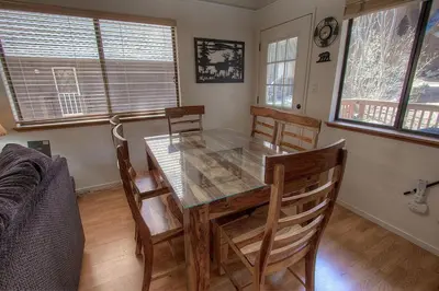 a dining room with a glass table and chairs at Cozy Mountain Hideaway home in Incline Village