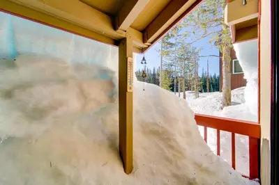 a snow ramp on a balcony with snow on it at 6 Mi to Sugar Bowl Resort Soda Springs Cabin! in Soda Springs