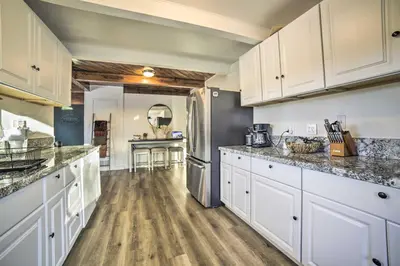 a kitchen with white cabinets and a refrigerator at Gateway to Mt Rose Ski! Reno Home with Fireplace in Reno