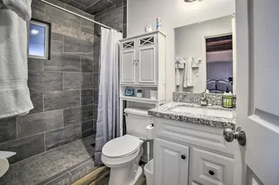 a white bathroom with a toilet and a sink at Gateway to Mt Rose Ski! Reno Home with Fireplace in Reno
