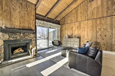 a living room with a fireplace and a leather couch at 1 Mi to Lake Tahoe Vacation Rental Home! in Stateline