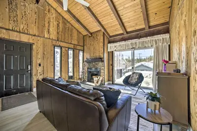 a living room with a leather couch and a fireplace at 1 Mi to Lake Tahoe Vacation Rental Home! in Stateline