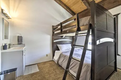 a bunk bed in a small room with a ladder at 1 Mi to Lake Tahoe Vacation Rental Home! in Stateline