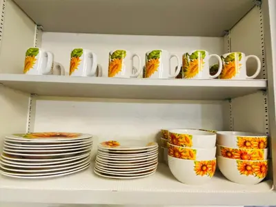 a group of cups and plates on a shelf at Family friendly, 3 bedroom house, with king bed for up to 15 - BBQ - Internet - jet tub in Auburn
