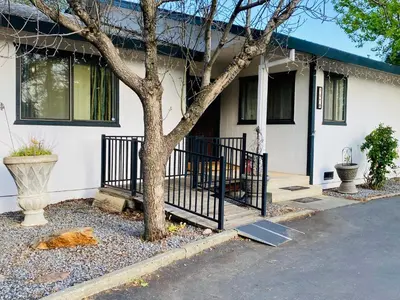 a house with a tree in front of it at Family friendly, 3 bedroom house, with king bed for up to 15 - BBQ - Internet - jet tub in Auburn