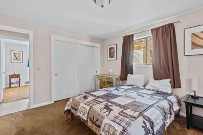 a bedroom with a bed and a window at Big Trees, Little Cabin in Arnold
