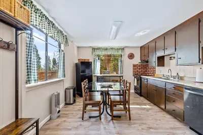 a kitchen with a table and chairs in it at Big Trees, Little Cabin in Arnold